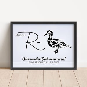 May include: A framed print featuring a black geometric duck illustration next to the text ENDLICH R- and the German phrases Wir werden Dich vermissen! and ZUM ABSCHIED ALLES GUTE. The design is presented in a simple black frame on a white background.