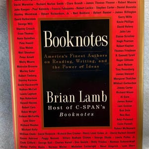 May include: A book cover for "Booknotes" by Brian Lamb, host of C-SPAN's Booknotes. The cover features a red and black design with white text, listing authors and the show's title. The book's theme is about reading, writing, and the power of ideas.