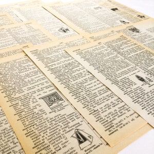 May include: A stack of vintage dictionary pages with black text on cream paper. The pages are open to various words, including "unready", "unreserved", "unrivaled", "unroll", "unruly", "unsaddle", and "unsavory".