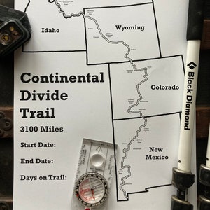 May include: A black and white map of the Continental Divide Trail, showing the trail route through Montana, Wyoming, Colorado, and New Mexico. The map includes the text "Continental Divide Trail", "3100 Miles", "Start Date", "End Date", and "Days on Trail". A compass and a hiking pole are also visible in the image.