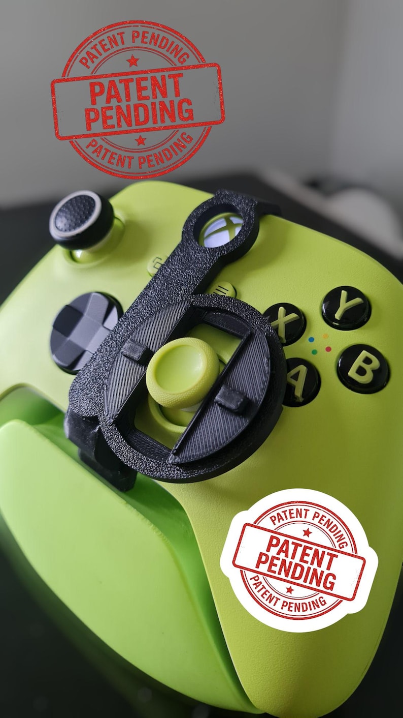 May include: A lime green video game controller with black buttons and a black attachment. The controller has the letters X, Y, A, and B in yellow. The text "PATENT PENDING" is stamped on the controller.