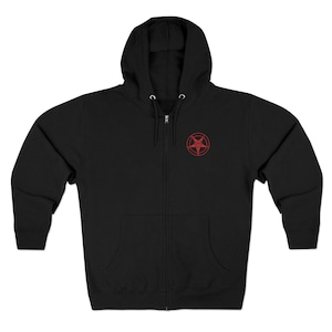 May include: Black zip-up hoodie with a hood and a red pentagram design on the upper left chest. The hoodie has a full zipper and two front pockets. The material appears to be a soft, comfortable fabric.