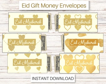 Puede incluir: Sobres de dinero Eid Mubarak de color crema con patrones de corazones dorados y texto. Cada sobre contiene un billete de dólar. Las palabras "Eid Mubarak" se muestran en dorado. La frase "Descarga instantánea" está en la parte inferior.