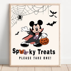 May include: A printable Halloween sign featuring a cartoon Mickey Mouse dressed as a vampire holding a jack-o-lantern. The sign says "Spooky Treats Please Take One!"