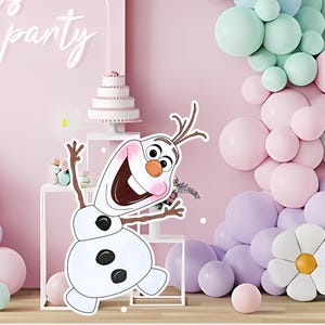 May include: A party backdrop featuring a large Olaf cutout from the movie Frozen, surrounded by pastel balloons and a decorative flower. The backdrop is pink with the words "let's party" in white script.