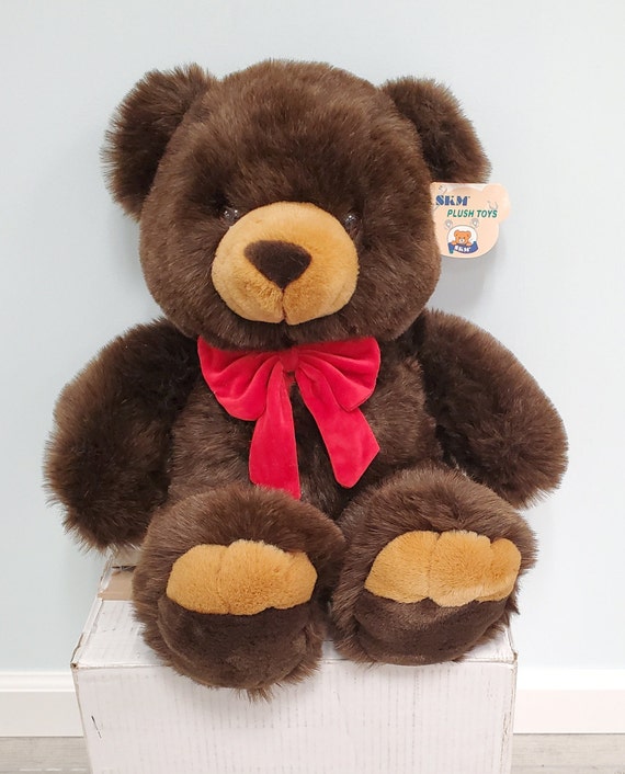 brown teddy bear with red bow tie