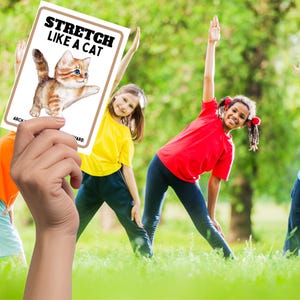 shows kids outside stretching with a teacher hand holding stretch like a cat.
