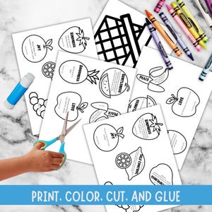 marble table background, has fruit papers with words like kindness, goodness, love, peace, gentleness, joy, self control, for each item from the Christian study lesson has blue stripe that says print, color, cut and glue. shows hand with scissors, glue stick, crayon.