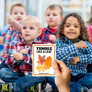 May include: A card with the text "Tumble Like A Leaf" and a picture of three colorful autumn leaves. The text "Spin and Fall Gently" is at the bottom of the card.
