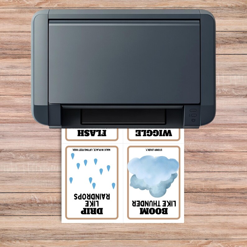 wood desktop table with a printer on the table with page coming off the printer with 4 of the springtime movement cards on it like drip like raindrops.