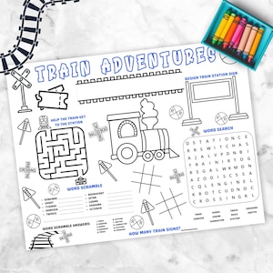 May include: A black and white activity placemat with the text "TRAIN ADVENTURES" and various train-themed games, including a maze, word search, and word scramble. A box of crayons is in the upper right corner.