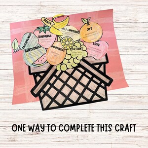 wood background, one way to complete this craft, shows a hand colored picnic blanket with picnic basket colored in brown, with gentleness, faithfulness, kindness, goodness, peace, self control, patient, joy, love on each piece of fruit for the Bible verse fruit of spirit.