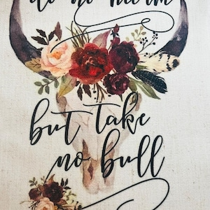 May include: A white bull skull with floral accents and the text "do no harm but take no bull" in black cursive lettering.