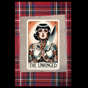 May include: Tarot card illustration featuring a woman with tattoos holding a large knife. The card is labeled "THE UNHINGED" and set against a plaid background. The woman has dark hair and is wearing a white top.