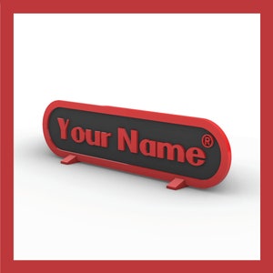 May include: Red and black desk nameplate with the text "Your Name" and a registered trademark symbol.