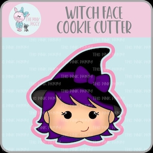 May include: A purple and black witch face cookie cutter with a pink bow on the hat. The cookie cutter is designed to create a witch face cookie.