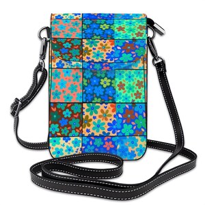 May include: A floral crossbody bag with a patchwork design. The bag features a black strap and a colorful pattern of flowers in shades of blue, orange, green, and brown. The bag is rectangular and has a silver-colored clasp.