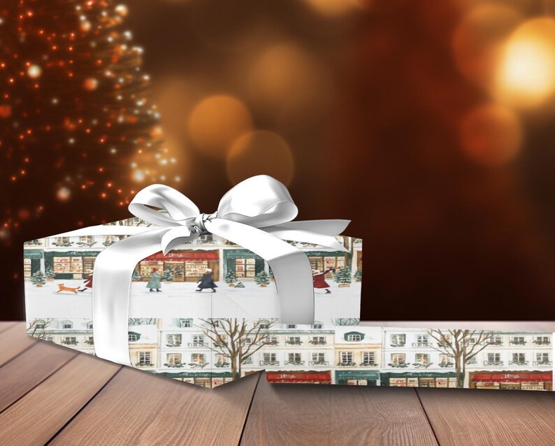 a present wrapped in white paper with a white bow
