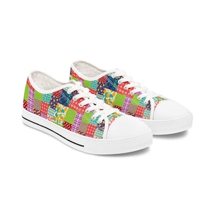 May include: A pair of colorful patchwork sneakers. The canvas shoes feature a vibrant patchwork design with squares of red, green, blue, and purple. The shoes have white laces, a white toe cap, and a black stripe along the sole.