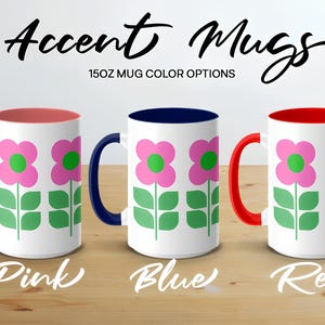 three mugs with different flower designs, each in a different color: pink, blue, and red.