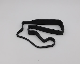 May include: Black 3D printed model of a race track. The track is shaped like a figure eight with a small loop in the middle.