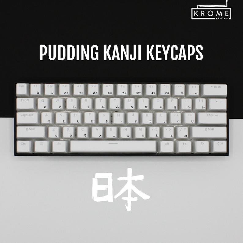 May include: White keyboard with Japanese characters on the keys. The keyboard has a black frame and a white space bar. The word "日本" is written in white on a grey background.