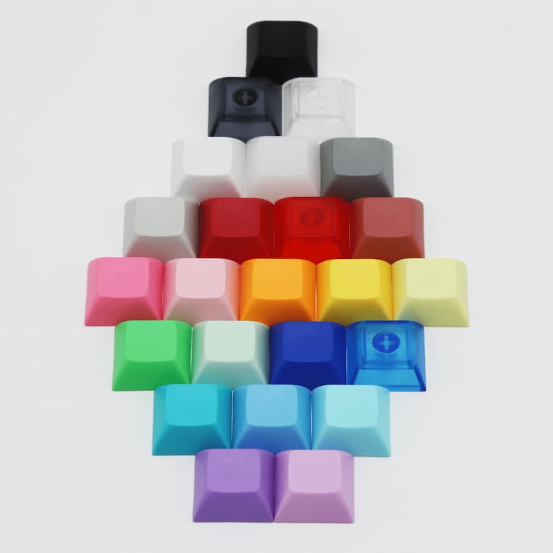 May include: A collection of colorful keycaps arranged in a pyramid shape. The keycaps are made of plastic and have a variety of colors, including pink, orange, yellow, green, blue, purple, and red.
