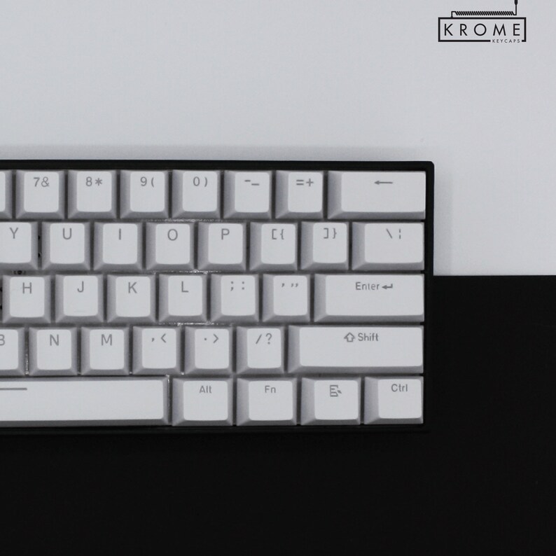 May include: A white mechanical keyboard with black keys and a black frame. The keys have white lettering and symbols. The keyboard has a row of function keys, a row of number keys, and a row of letter keys. The keyboard also has a space bar, an enter key, a shift key, a control key, an alt key, and a function key.