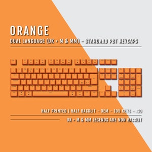 May include: An orange keyboard with dual language (UK + M & MM) standard PBT keycaps. The keyboard has 105 keys and is half printed and half backlit. The word "ORANGE" is at the top of the image.