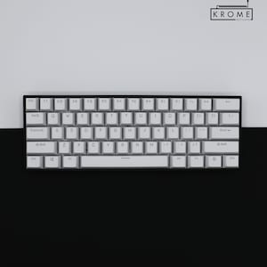May include: A white mechanical keyboard with black keys and a black frame. The keys have white lettering and the keyboard has a space bar with a black stripe.