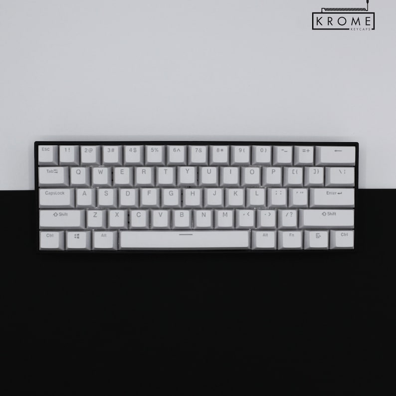 May include: A white mechanical keyboard with black keys and a black frame. The keys have white lettering and the keyboard has a space bar with a black stripe.