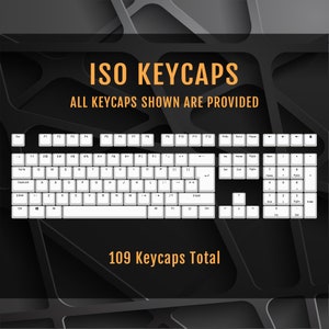 May include: A white keyboard with black lettering, showing all 109 keycaps. The keyboard is on a black background with a geometric pattern.