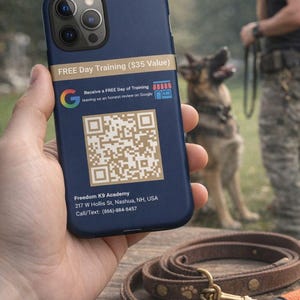 May include: A navy blue phone case with a QR code and text promoting free dog training. The case also displays the Freedom K9 Academy's contact information. A brown leather dog leash and gloves are in the foreground, with a dog and trainer in the background.
