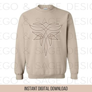 May include: A beige sweatshirt with a brown and white embroidered design on the front. The design is a stylized floral pattern with a central point.