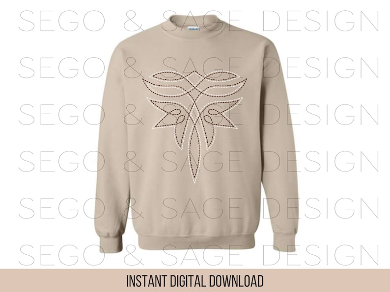 May include: A beige sweatshirt with a brown and white embroidered design on the front. The design is a stylized floral pattern with a central point.
