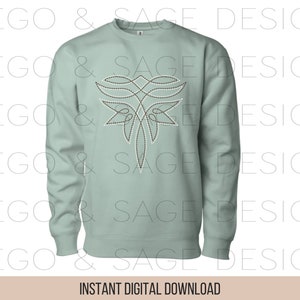 May include: A light green sweatshirt with a brown and white geometric design on the front. The design resembles a stylized butterfly.
