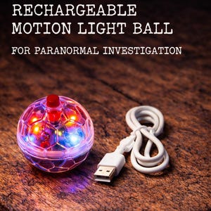 May include: A rechargeable motion light ball for paranormal investigation. The clear ball has a red top and is connected to a white USB cable. The ball is lit with red, orange, and blue lights. The text on the image reads: "RECHARGEABLE MOTION LIGHT BALL FOR PARANORMAL INVESTIGATION."
