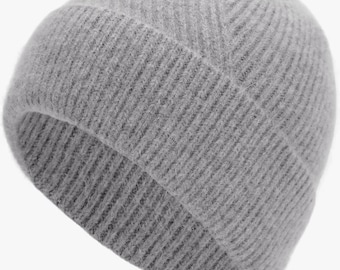 May include: A light gray beanie hat featuring a thick, ribbed knit texture. The cap has a wide, folded cuff at the base and a rounded crown, constructed from a soft, fuzzy material that provides a consistent, monochromatic appearance throughout.