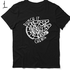 May include: Black t-shirt featuring a white graphic of the Millennium Falcon spaceship and the text "Punch It Chewie".