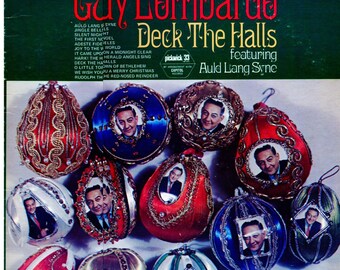 May include: Vintage Christmas album cover featuring Guy Lombardo and the title "Deck the Halls." The album cover displays a collection of decorative Christmas ornaments with a portrait of Guy Lombardo. The album is a Pickwick 33 release.