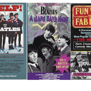 May include: Three VHS tapes featuring the Beatles. The first tape is titled "Help! With The Beatles" and features the band in winter clothing. The second tape is titled "Beatles A Hard Day's Night" and features a close-up of the band. The third tape is titled "Fun With The Fab Four" and features a documentary of the Beatles.