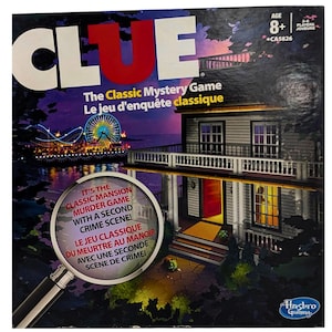May include: Clue board game box with the title in white and red. The artwork shows a mansion, a Ferris wheel, and the text "The Classic Mystery Game". The game is for 3-6 players, ages 8+.