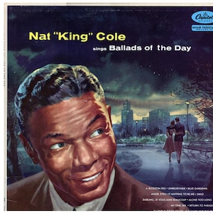 May include: Album cover for Nat "King" Cole's "Ballads of the Day." The image features a portrait of Cole with a smiling expression. The background shows a couple walking in a park with a city skyline. The Capitol Records logo is visible.