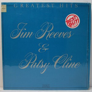 May include: A blue vinyl record album cover with the title "Greatest Hits" and the names "Jim Reeves & Patsy Cline" in silver script. A red and white "Best Buy Series" sticker is in the upper right corner.