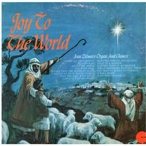 May include: Vintage album cover art with the title "Joy To The World" in orange script. The image depicts shepherds, sheep, and a bright star, with text listing Christmas carols. The album is by Ivan Ditmars.