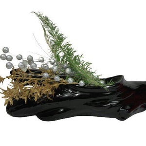 May include: Black ceramic planter shaped like a tree branch with a green fern and gold and silver decorative sprigs.