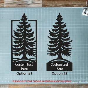 May include: Two black fir tree designs for custom text, Option #1 in a rectangle and Option #2 with a base. The text reads "Custom text here" and "Option #1" and "Option #2". The text at the bottom says "PLEASE PUT FONT CHOICE IN PERSONALIZATION FIELD".