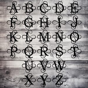 May include: Black metal alphabet letters A through Z with decorative flourishes. Each letter is a unique design, perfect for personalized decor. The letters are arranged in rows on a wooden background.