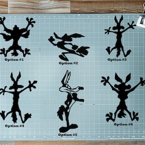 May include: Six black silhouette options of a cartoon coyote character, each in a different pose. The options are labeled with numbers and the word "Option". The coyote is a popular cartoon character.