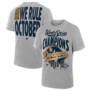 May include: A heather gray t-shirt featuring the text "World Series Champions" and "Dodgers 2025" in navy blue and gold. The back of the shirt displays "We Rule October" in navy blue. A baseball-themed apparel item.